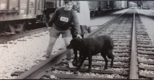 A black-and-white photo of Deb Cunningham and a dog